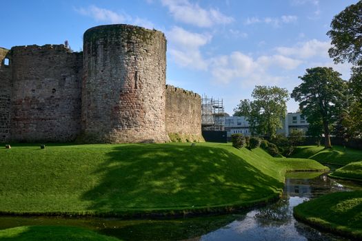 Capture of Rothesay Castle with lush green landscape and summer sky in Scotland.