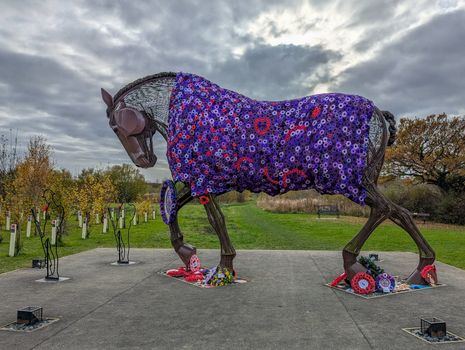 Metal horse sculpture with a colorful poppy quilt in Featherstone, England.