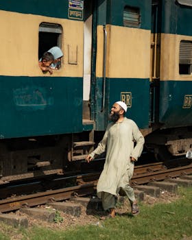 A candid moment at a Dhaka railway station showcasing everyday life and human connection.