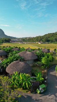 Aerial view of traditional round houses amidst lush greenery in Guangxi, China.