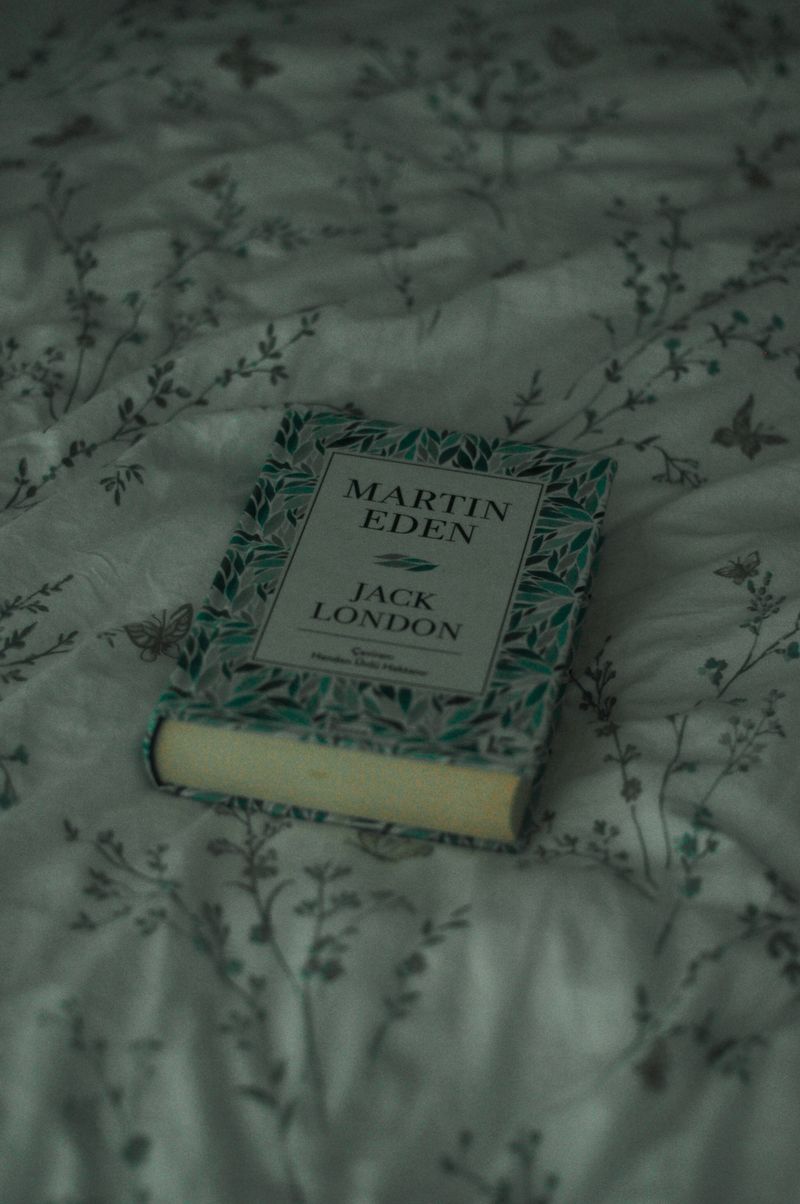 Martin Eden book on floral bedsheet