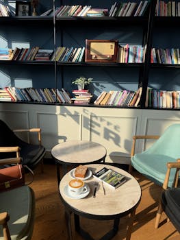 A tranquil café scene in İstanbul with books, coffee, and ambient lighting.