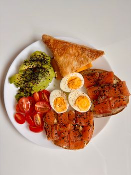 Delicious platter of avocado, salmon, eggs, and more for a healthy start.