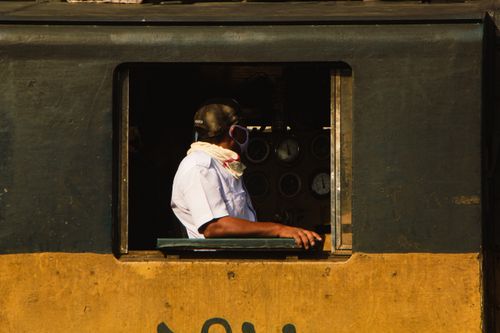 Free A train engineer controls the locomotive, captured in Dhaka, Bangladesh. Stock Photo