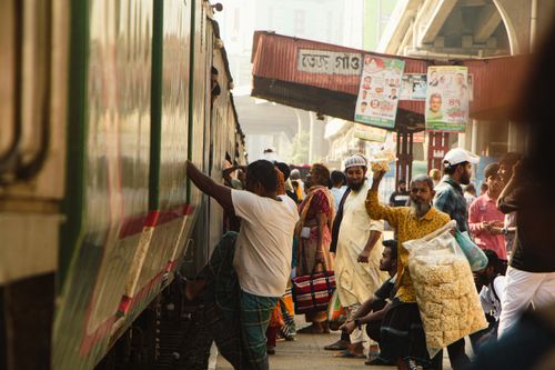 Free Active crowd at Dhaka railway station during daytime capturing daily hustle. Stock Photo