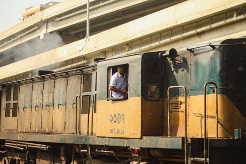 Free A train approaches Dhaka railway station with a visible driver in the cabin. Stock Photo