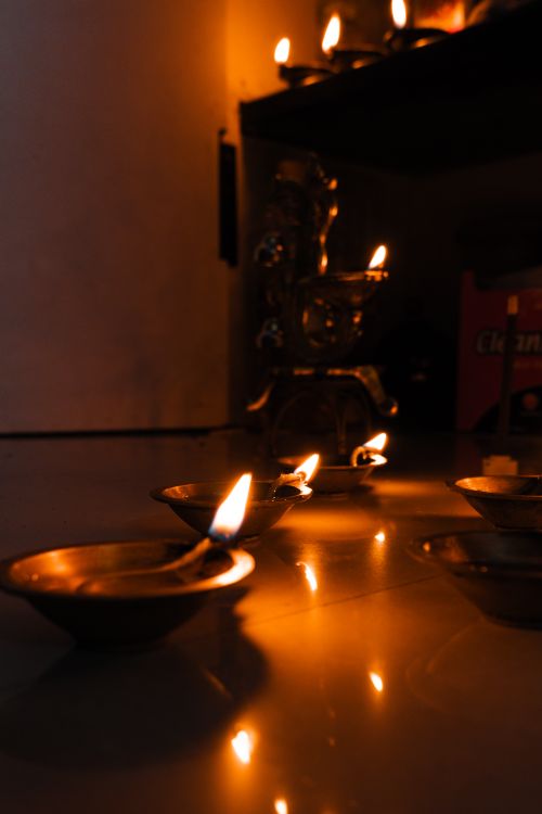 Free Illuminated Diwali diyas creating a warm festive atmosphere in Bengaluru, India. Stock Photo