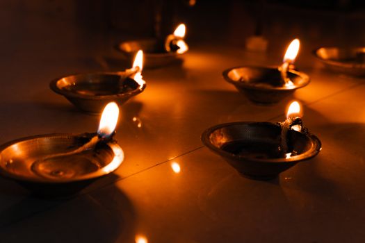 Brass diyas lit during Diwali, creating a warm and festive ambiance.