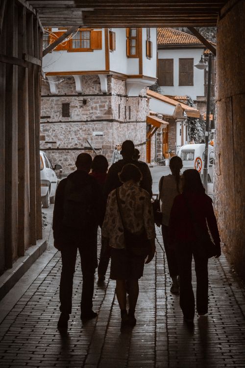 Free People walking under an archway in Antalya, Türkiye, showcasing historic architecture. Stock Photo