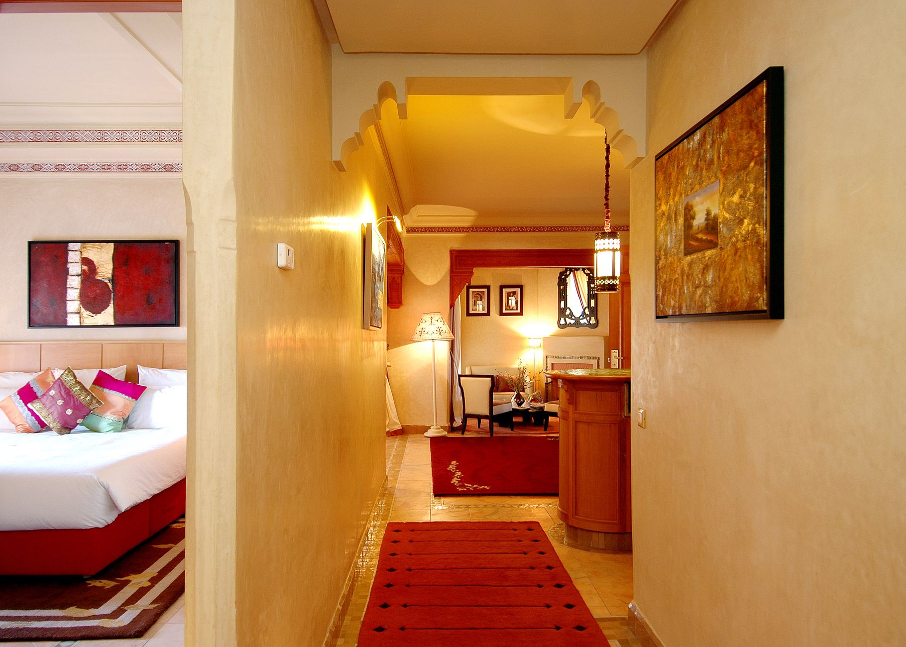 Warm, elegant hotel suite living area with soft lighting and rich textures
