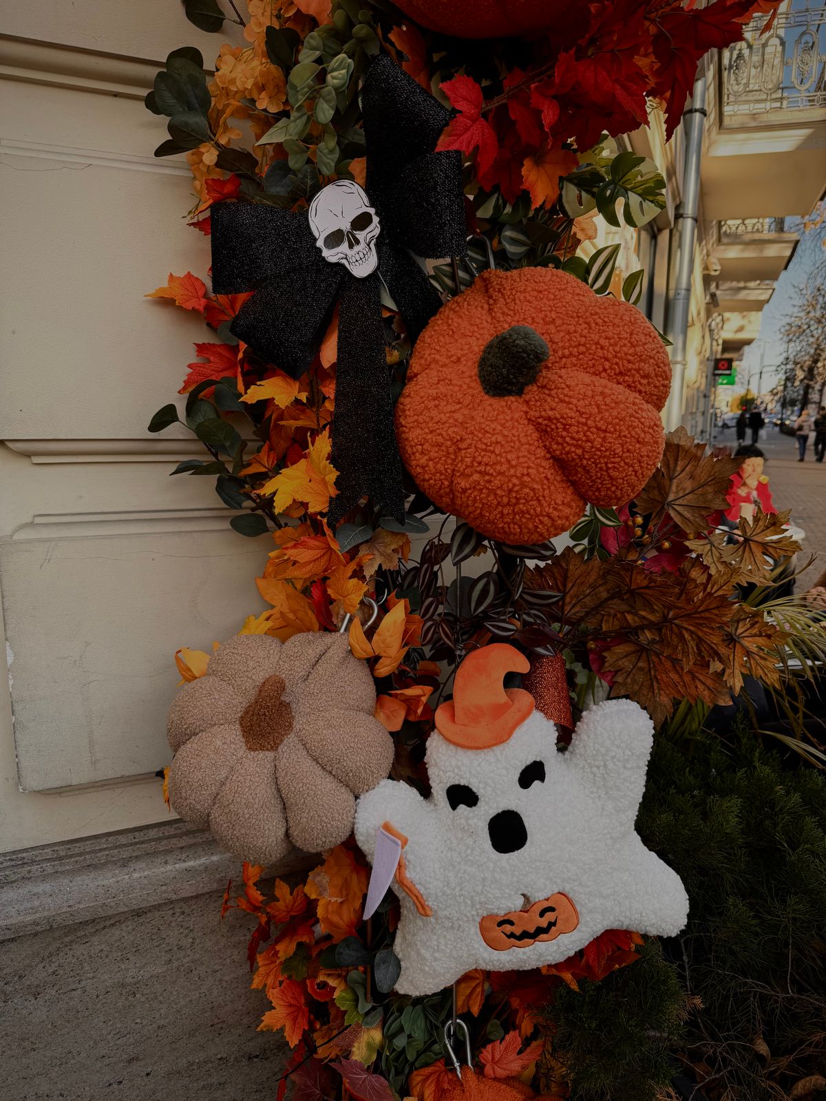 Autumn Halloween decorations with plush pumpkins and a ghost