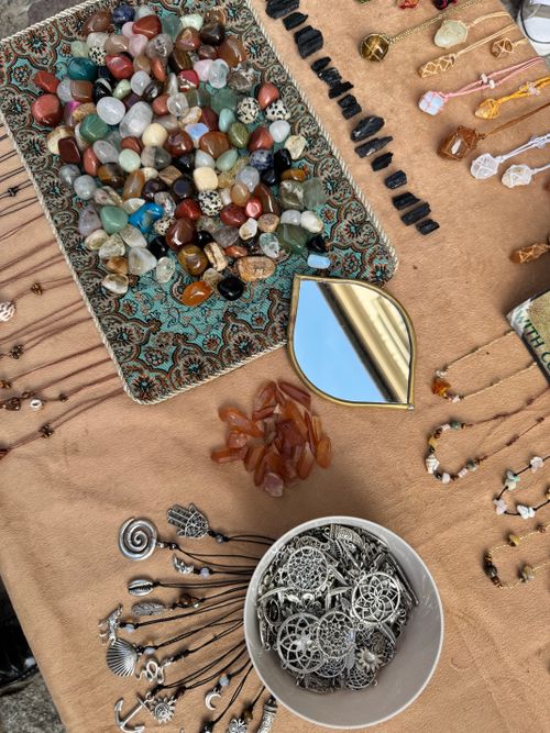 Free Vibrant collection of gemstones and silver jewelry laid out on a patterned cloth display. Stock Photo