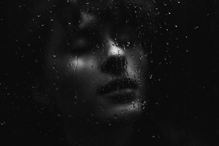 Woman Face Behind Wet Glass