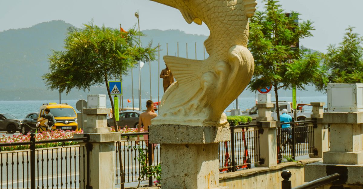 Fish Statue Rabat Sculpted Fish Statue by Waterfront Promenade · Free Stock Photo