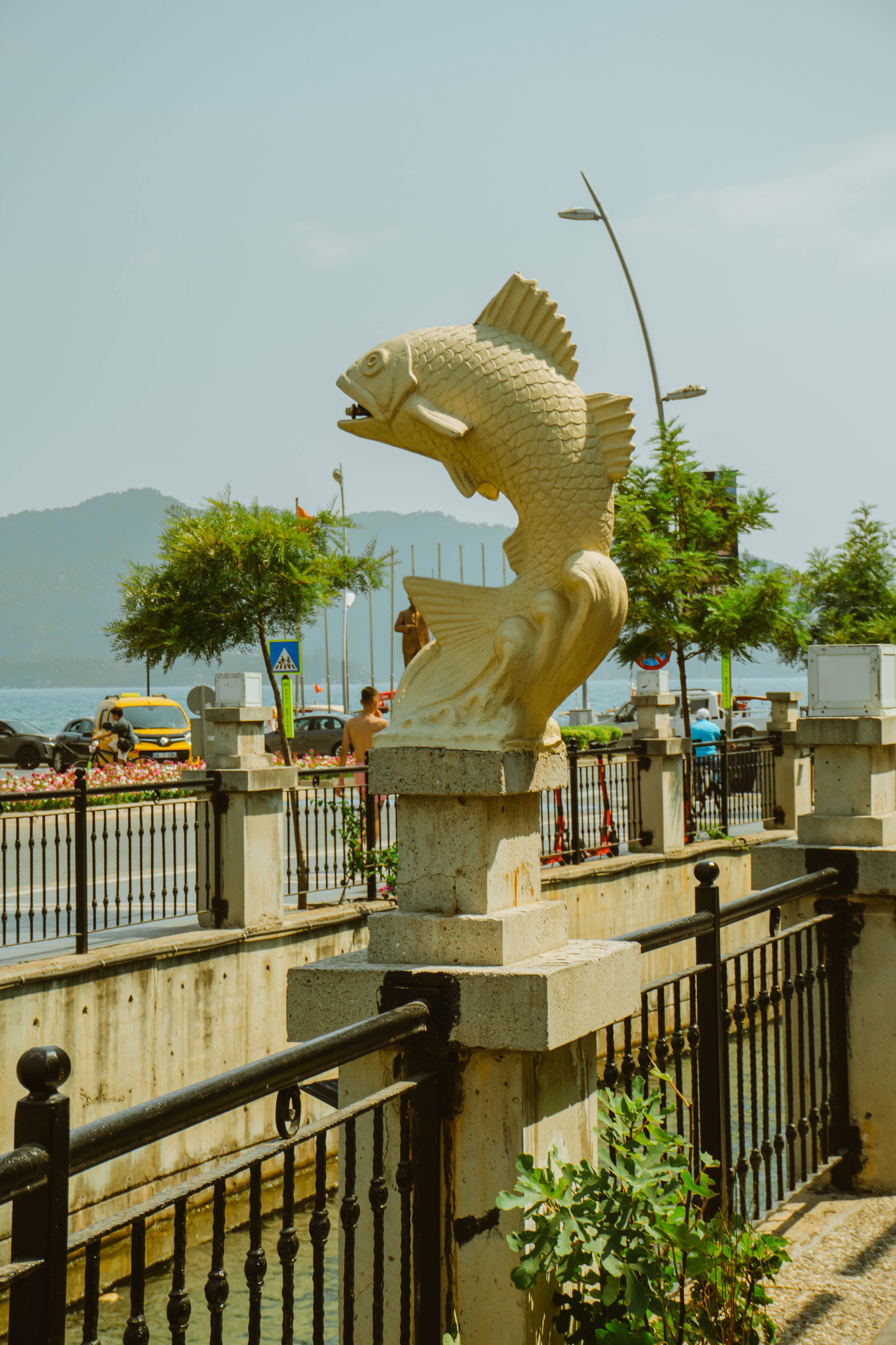 Sculpted Fish Statue by Waterfront Promenade · Free Stock Photo