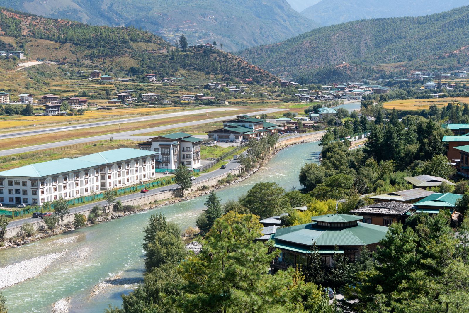 The Paro Chhu running past the town and the long runway of Paro airport on the valley floor, ridges beyond