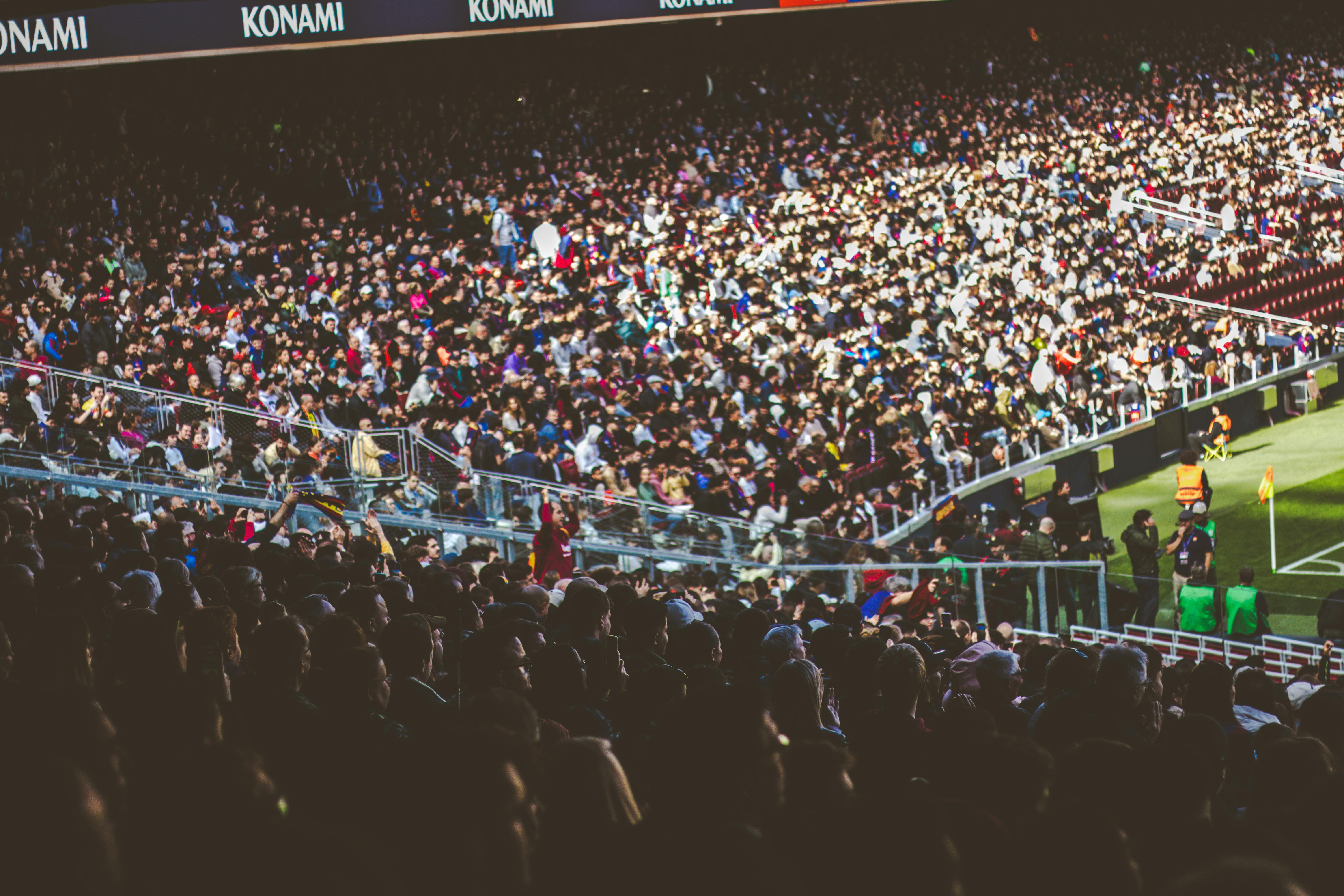 A crowded soccer stadium packed with enthusiastic fans during a match.