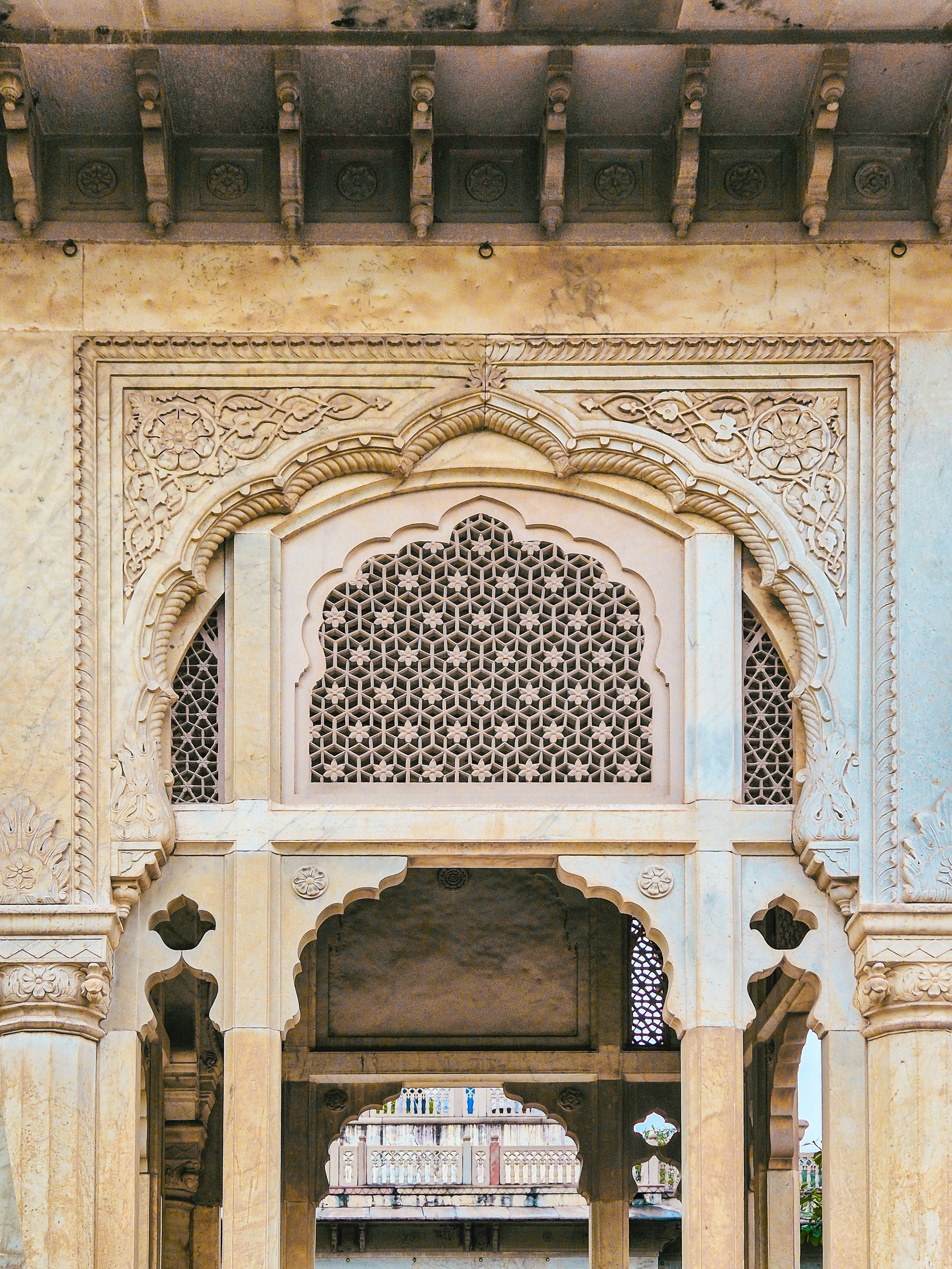 Ornate Mughal architecture featuring intricate stone carvings at Amber Fort in Jaipur, India.