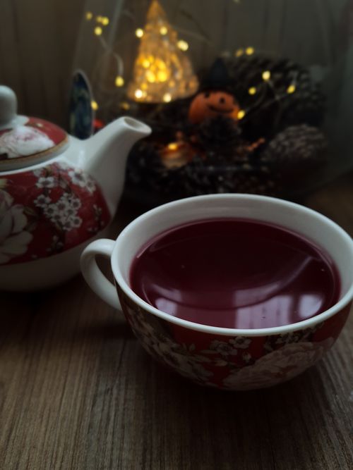 Free A warm cup of tea with a floral teapot on a wooden table, capturing autumn vibes indoors. Stock Photo