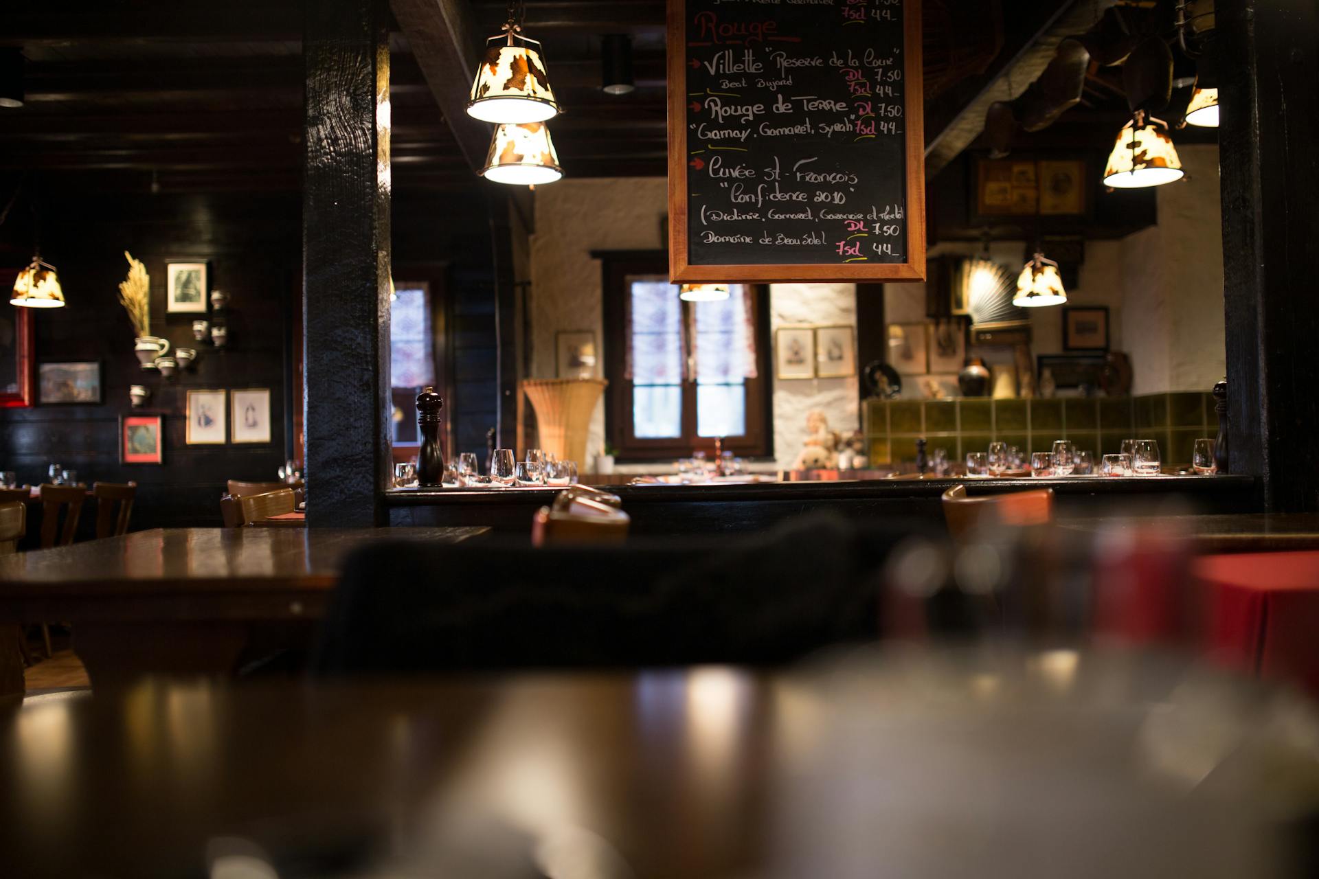 Warm and inviting interior design of a vintage-style restaurant with wooden furnishings and dim lighting.