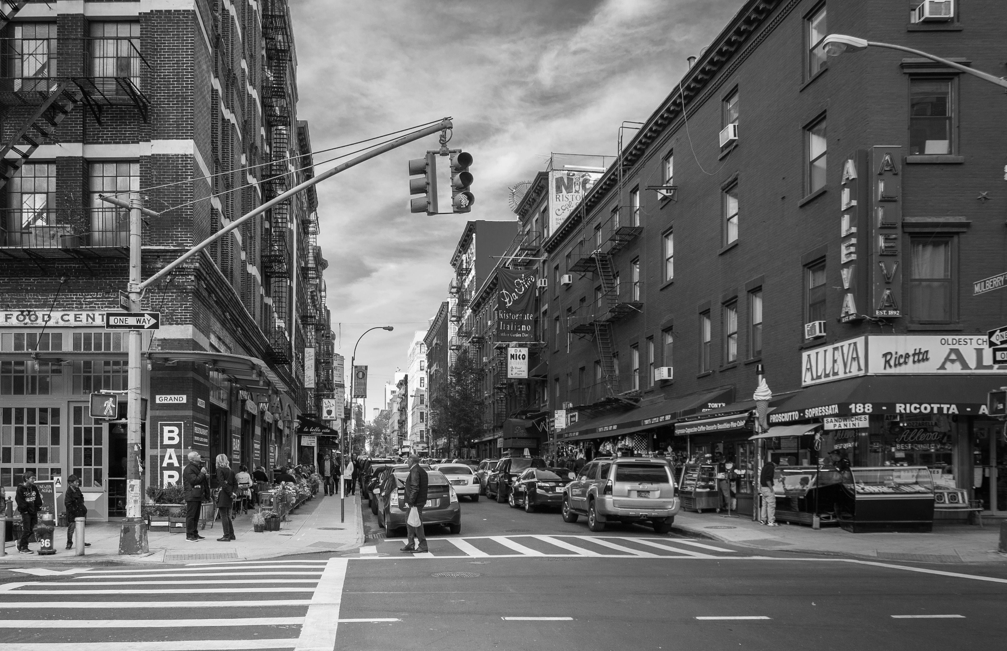 Monochrome cityscape of Little Italy, showcasing bustling streets and historic buildings.