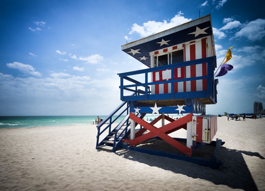 Colorful lifeguard tower with American flag design on Miami Beach.