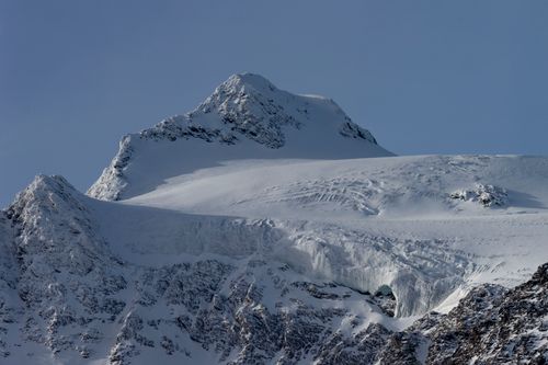 Free Stunning view of a snow-capped mountain peak under a clear blue sky in winter. Stock Photo
