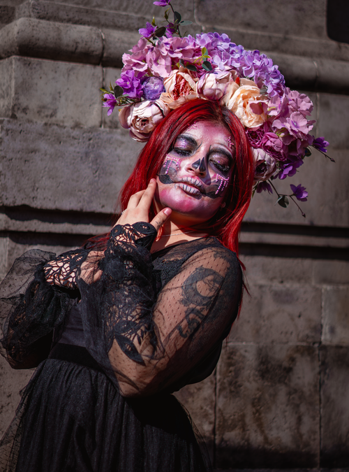 Free Celebration of Day of the Dead with vibrant floral crown and face paint. Stock Photo