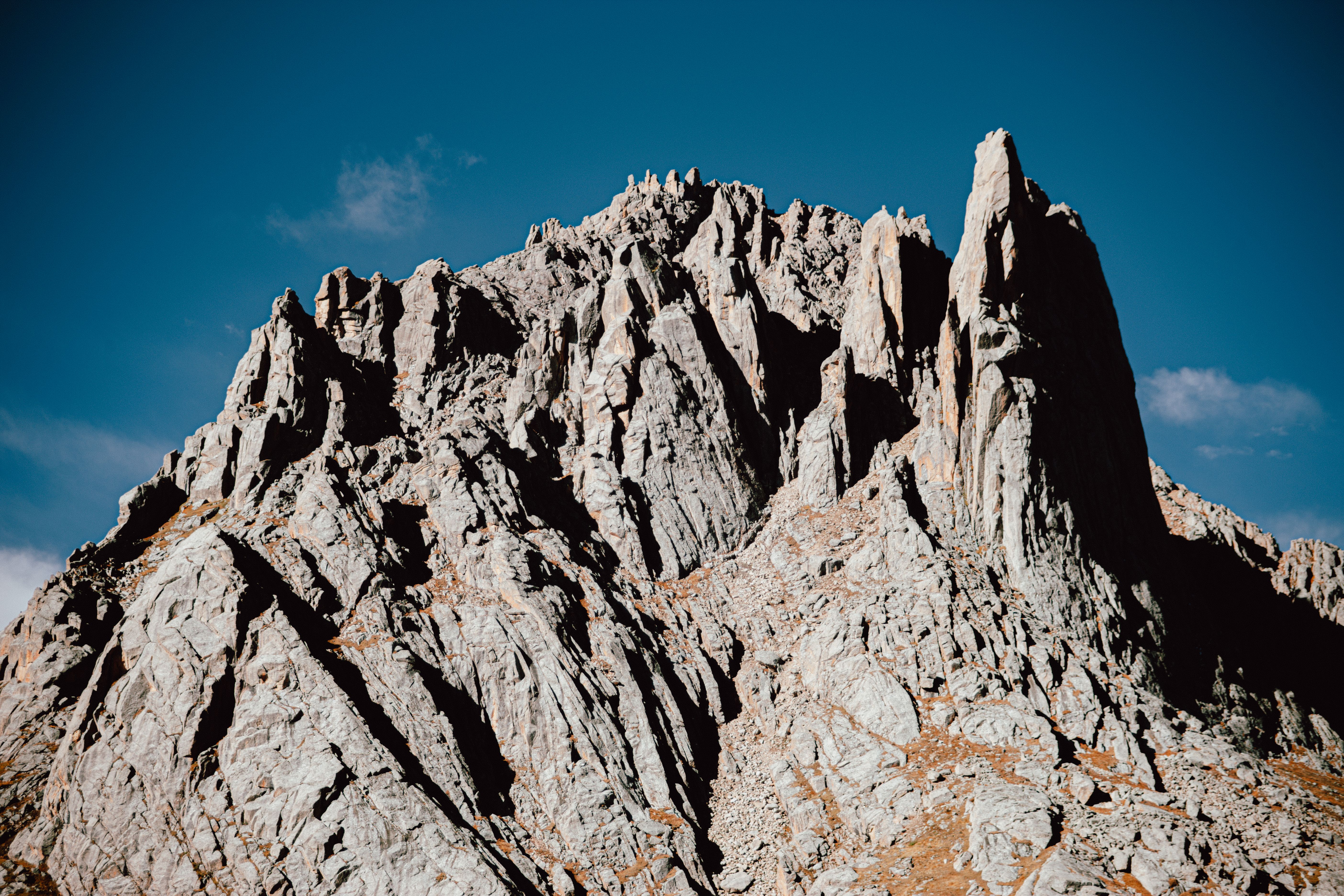 Rugged Mountain Peak Against Clear Blue Sky · Free Stock Photo
