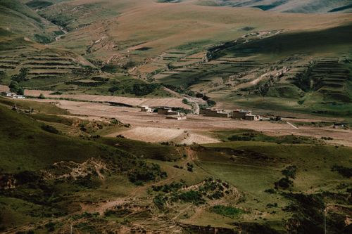 Free A stunning view of a rural valley with terraced fields and small settlements, ideal for peaceful retreats. Stock Photo
