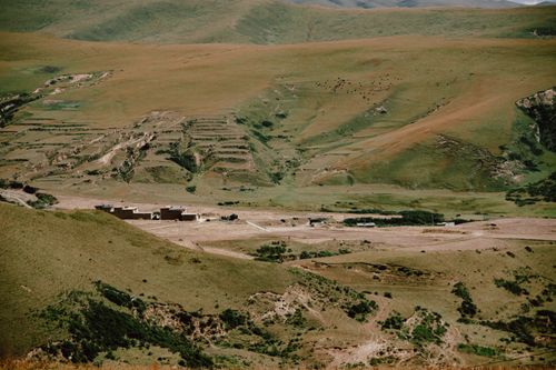 Free Aerial view of vast rolling hills with sparse vegetation and earth tones, highlighting natural terrain. Stock Photo