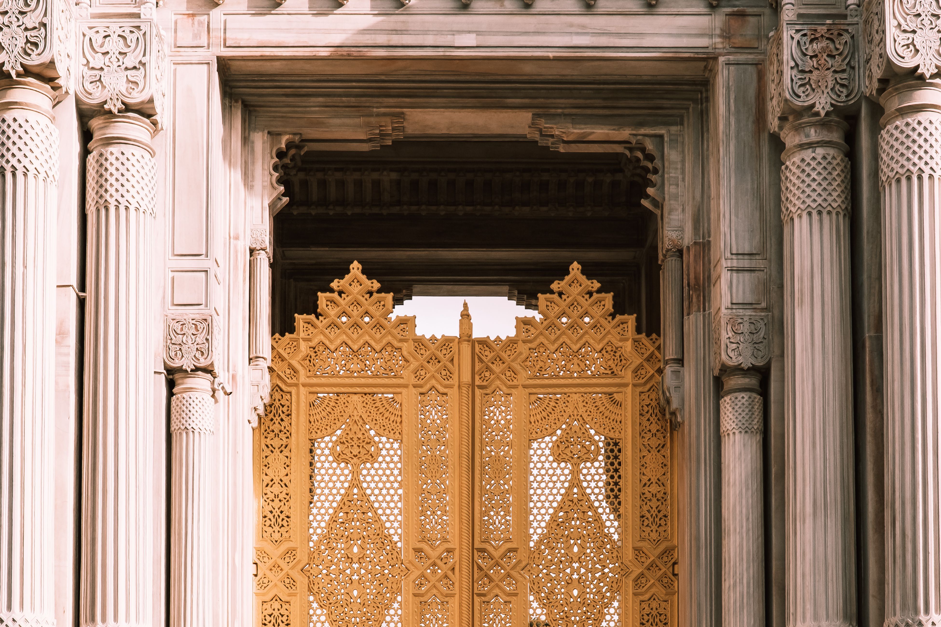 Intricate golden gate and detailed columns showcase classic architectural style.
