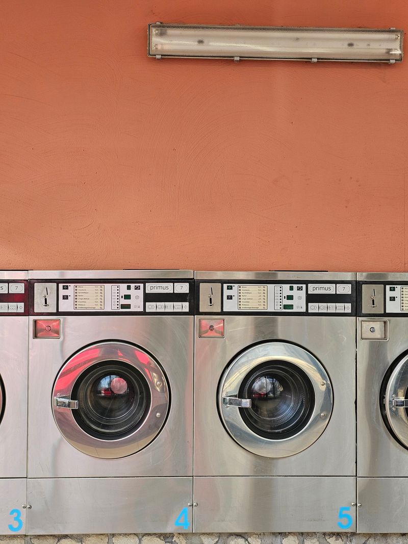 Row of commercial washing machines at FreshPress