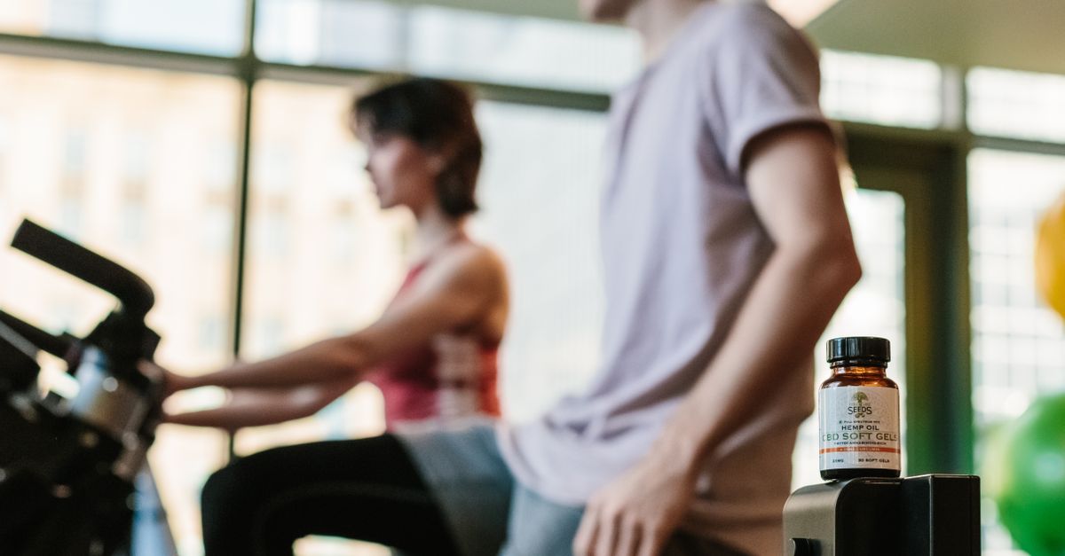 CBD gel bottle in gym with exercising adults, suggesting health benefits. - Evidence evidence guide for collagen exercise recovery meta-analysis