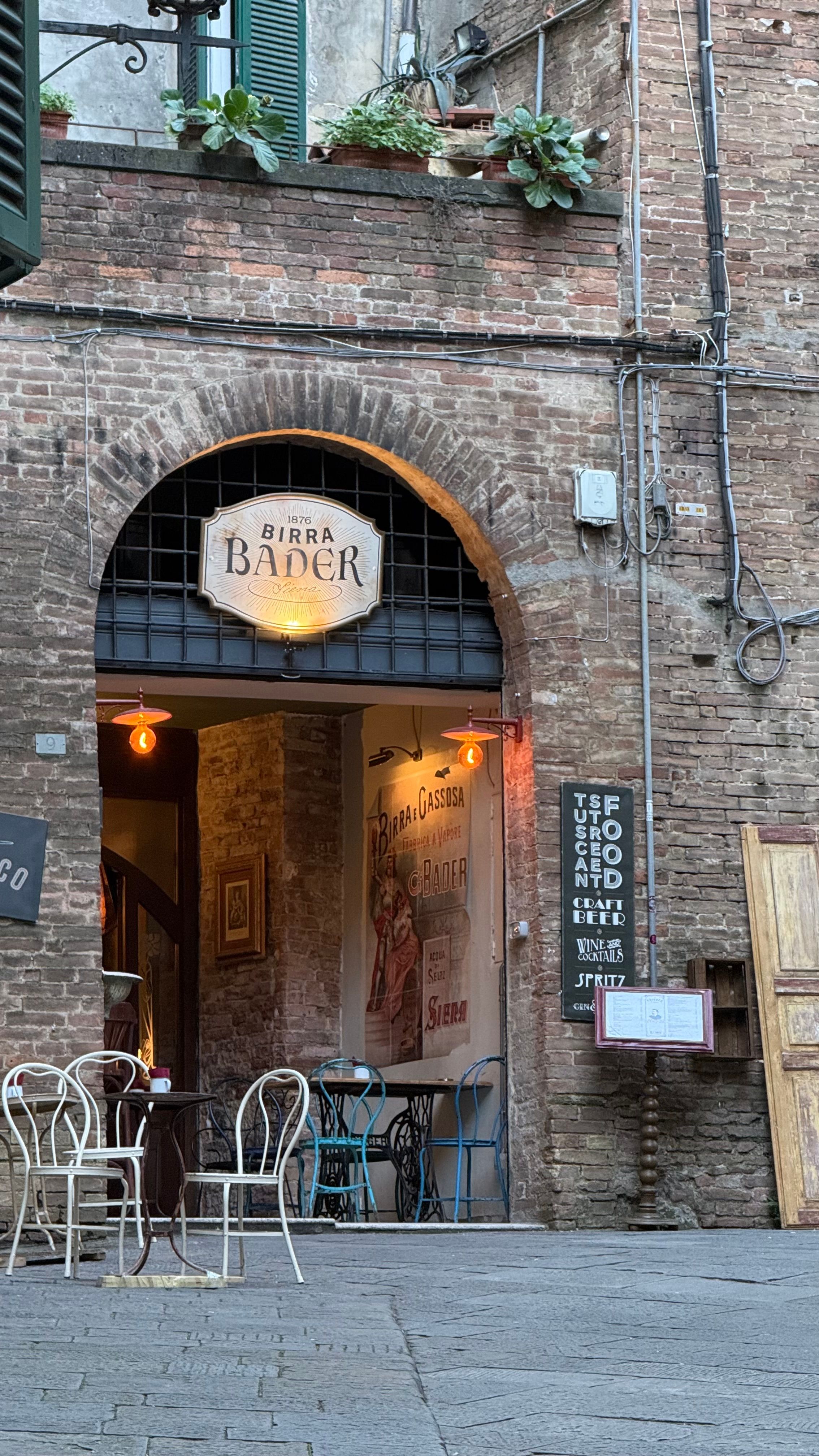 Picturesque view of an Italian café entrance on a historic street.
