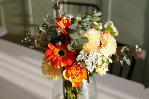 Free Bright bouquet featuring orange gerbera, roses, and white hydrangeas in natural light. Stock Photo