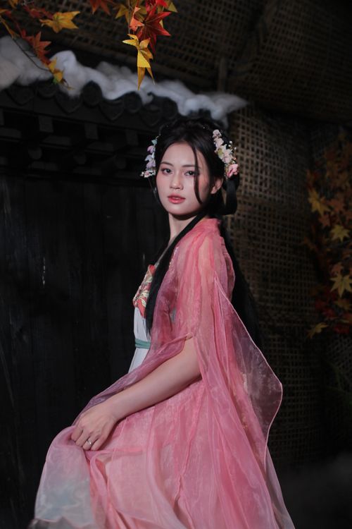 Free Portrait of a woman in traditional Chinese dress with floral hair decorations, set indoors. Stock Photo