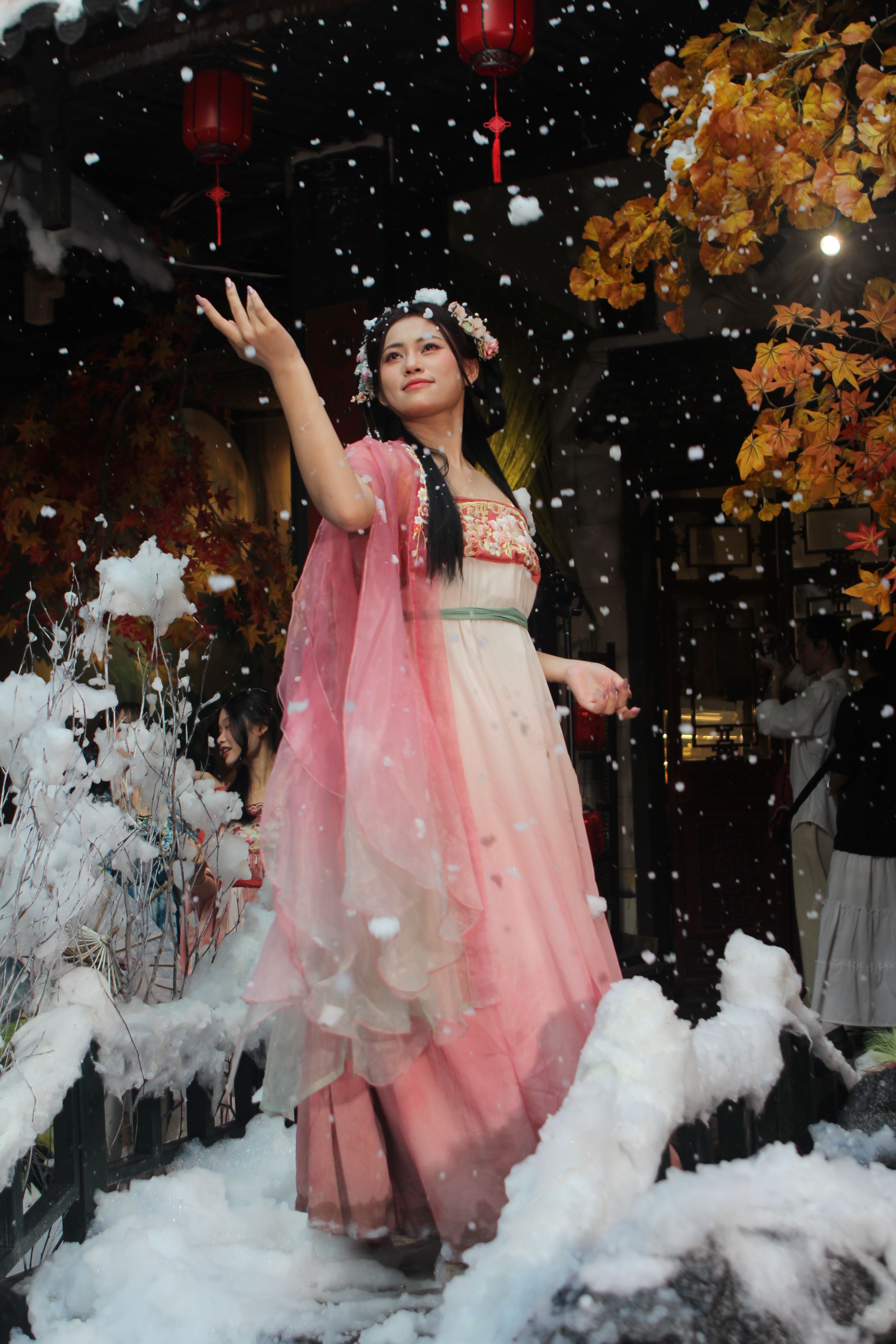 Elegant Woman in Traditional Dress Amid Snowfall  Free Stock Photo