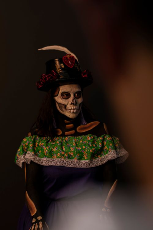Free Woman in traditional Day of the Dead attire with intricate skull face paint. Stock Photo