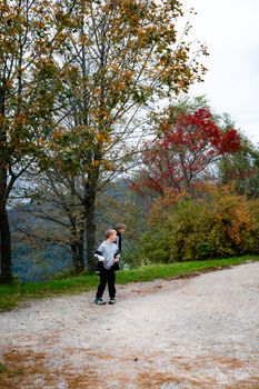 Two kids walking on a scenic autumn path in Baden-Württemberg, Germany. Perfect for outdoor and travel themes.