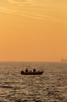 A serene scene of a small boat at sunrise in the waters of İstanbul.