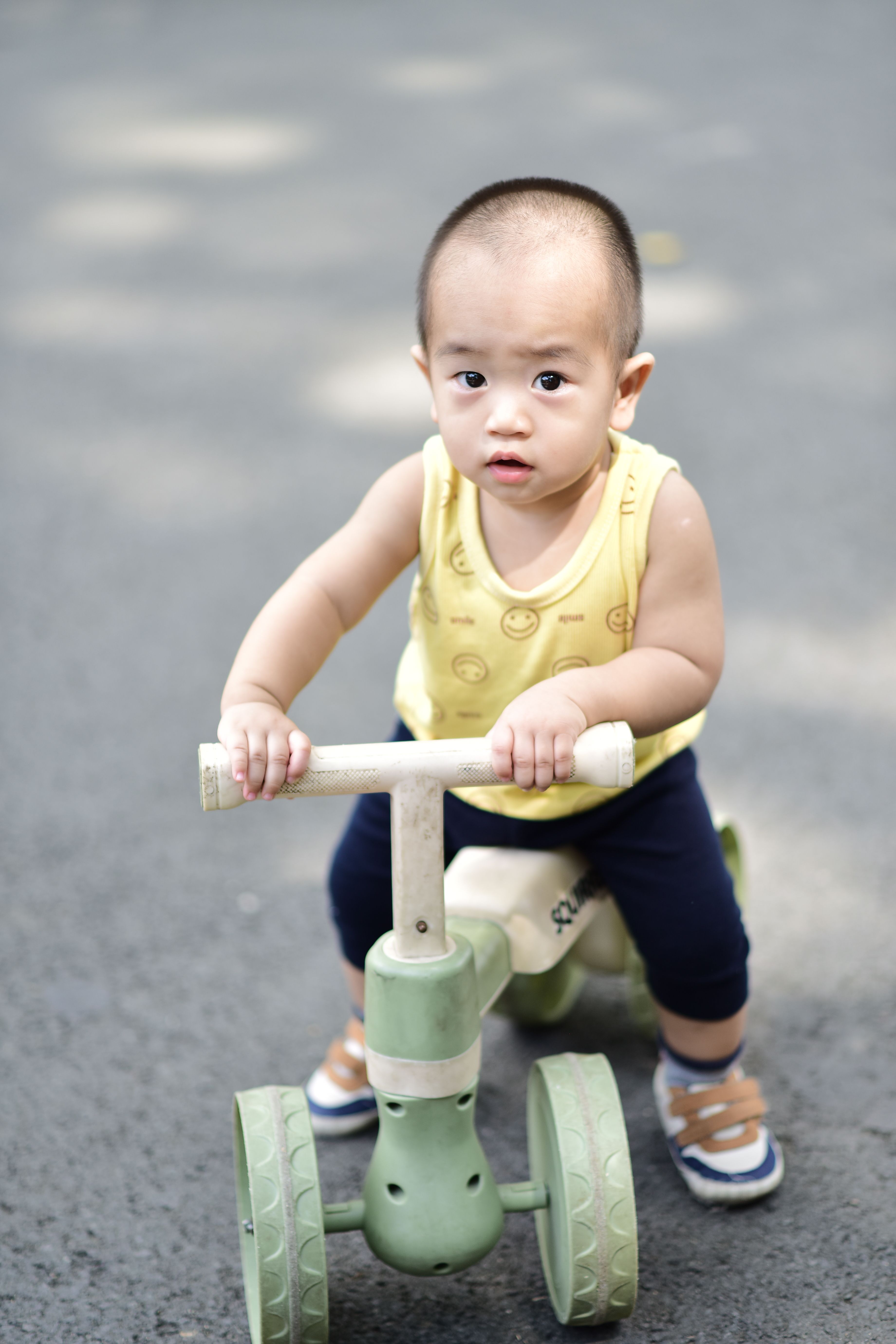 Adorable Baby Riding Toy Scooter Outdoors · Free Stock Photo