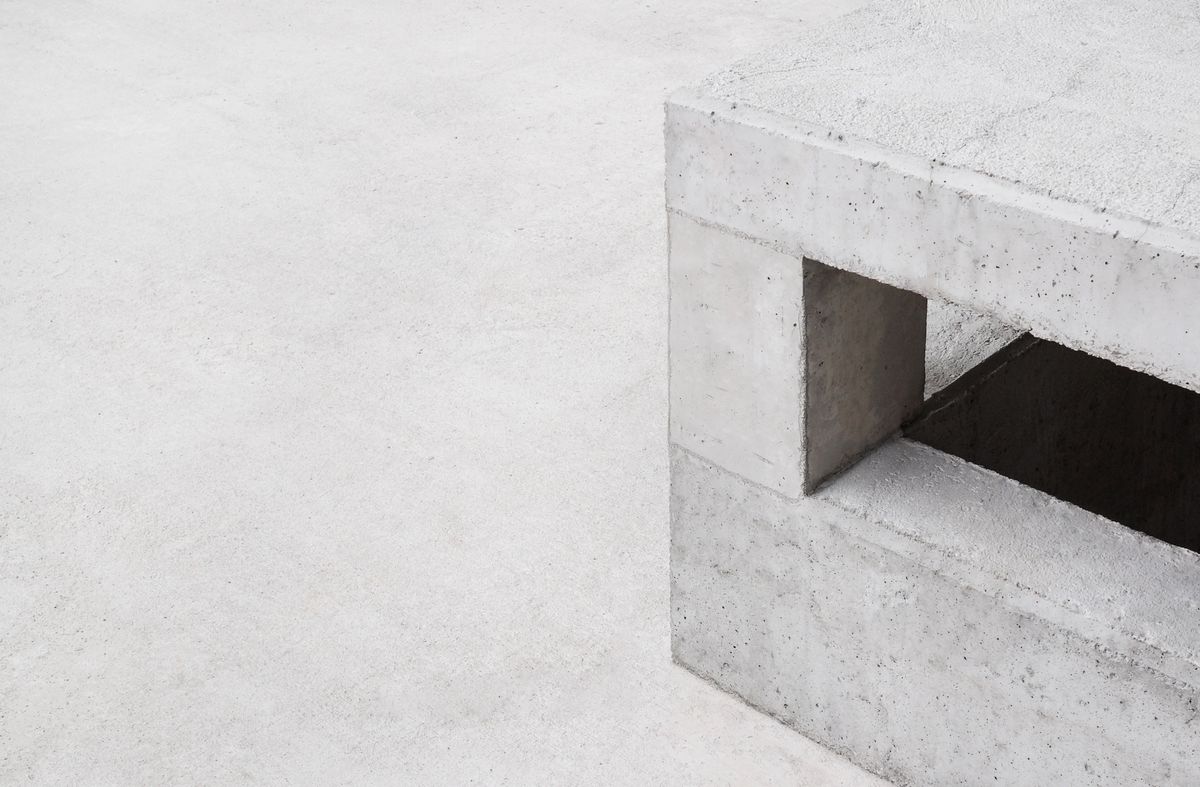 A minimalist concrete structure with clean geometric lines.