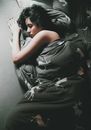 Top view of relaxed female covered with warm blanket sleeping in bed in morning