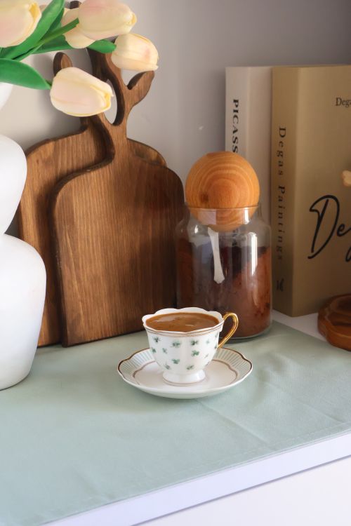 Free Elegant kitchen scene with coffee cup, books, and decor. Stock Photo