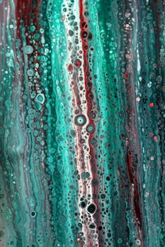 Vibrant abstract artwork with aqua and red paint textures creating a flowing pattern.
