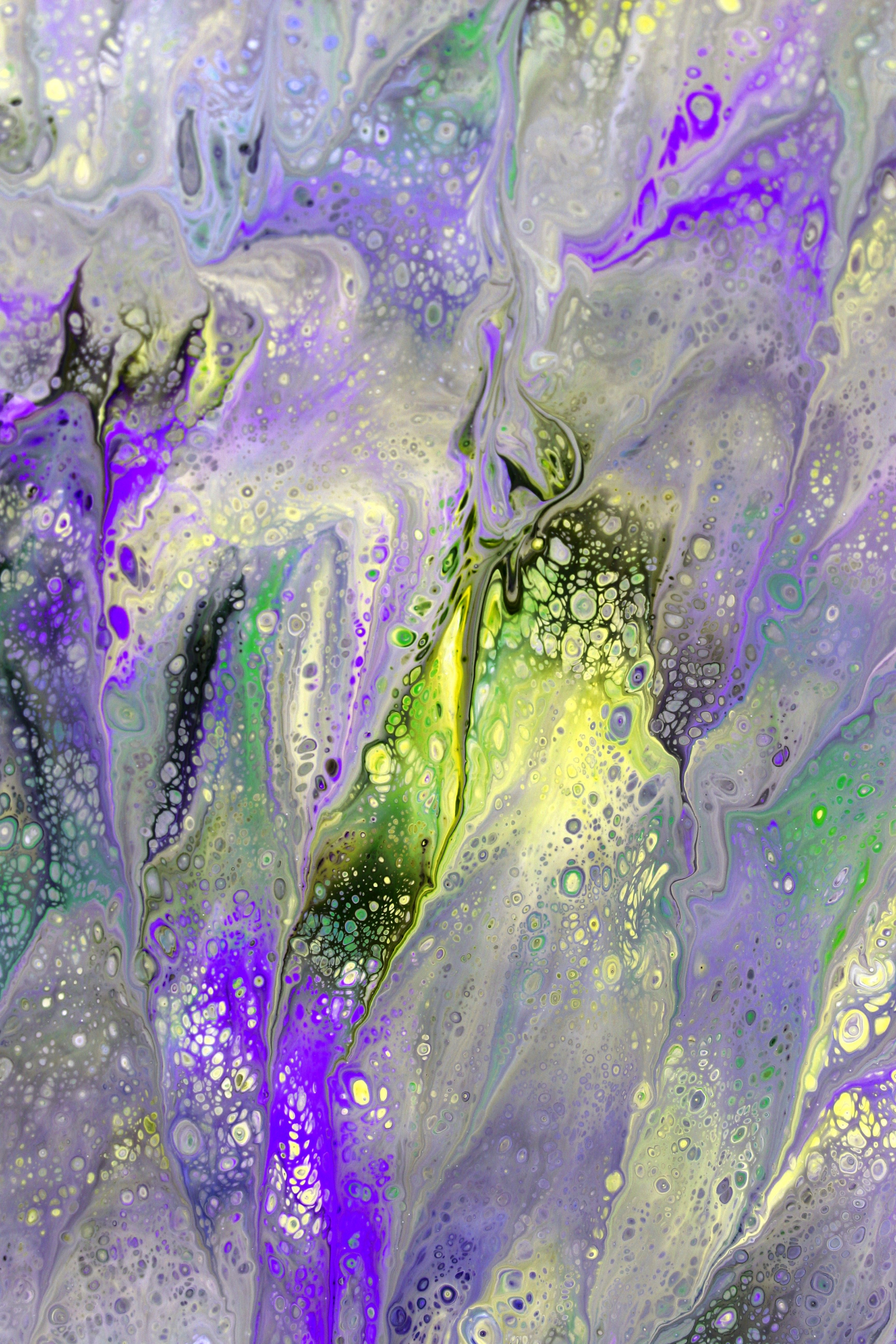 Dynamic fluid art with purple and green swirls creating a captivating abstract pattern.