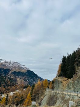 Captivating mountain landscape with autumn foliage and a drone, showcasing natural beauty and technology.