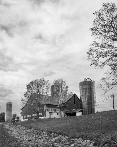 Free Black and white farm landscape with barn and silos, Muncy, PA. Stock Photo