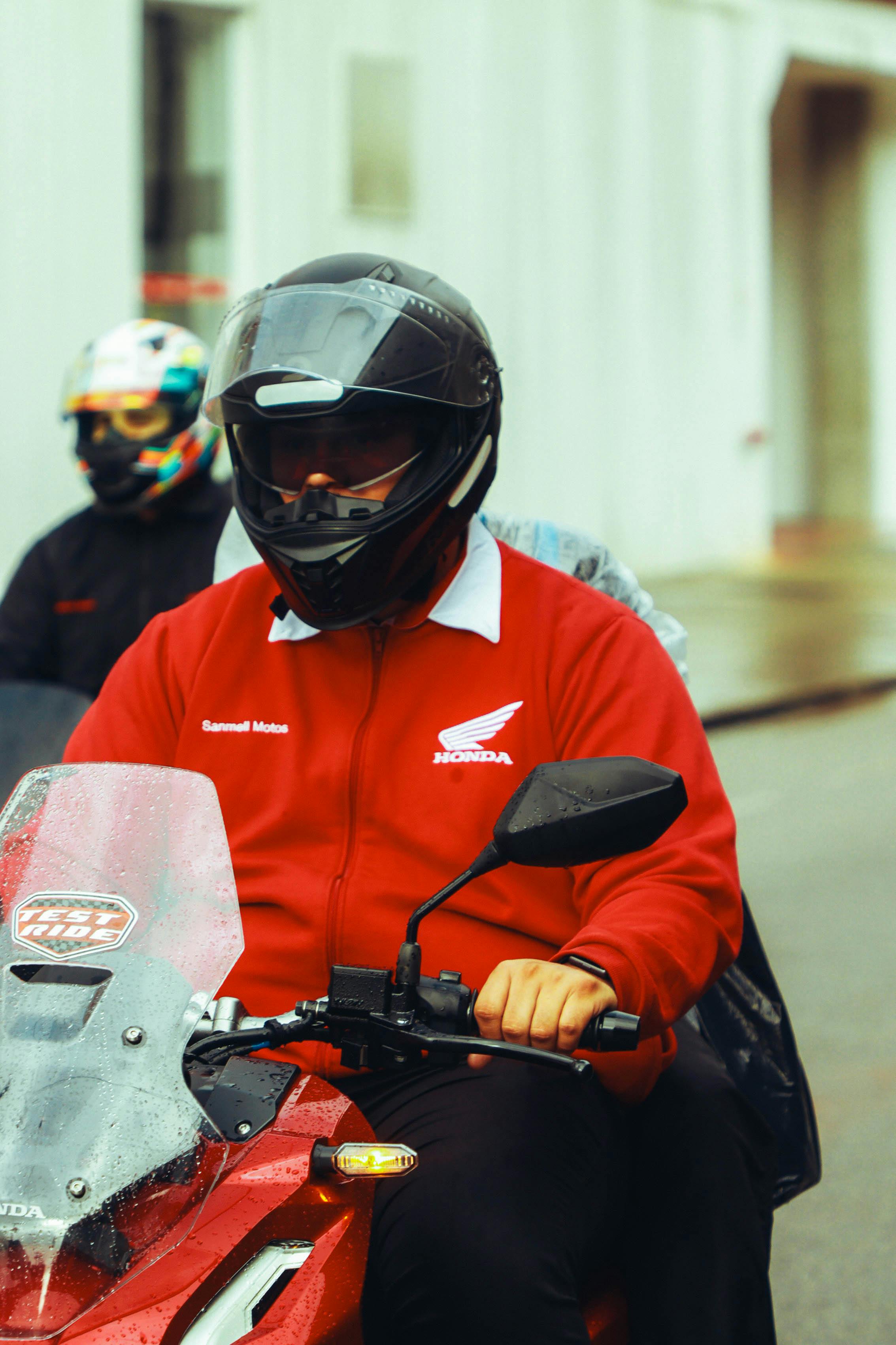 Motorcyclist riding Honda bike on a street in Santos, Brazil.